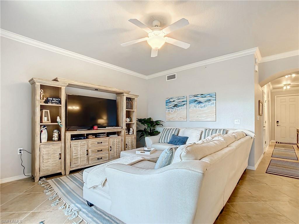 9715 Acqua Court, Unit 127 Naples, FL 34113 - Photo 25 of 50 a living room with furniture and a flat screen tv