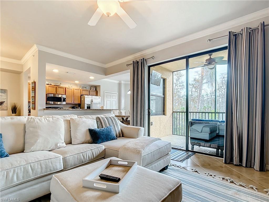9715 Acqua Court, Unit 127 Naples, FL 34113 - Photo 27 of 50 a living room with furniture and a large window