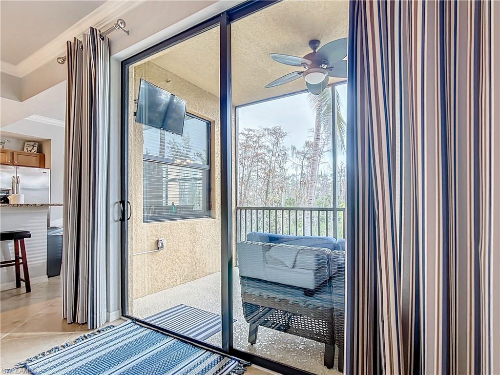 9715 Acqua Court, Unit 127 Naples, FL 34113 - Photo 28 of 50 a bedroom with furniture and a window