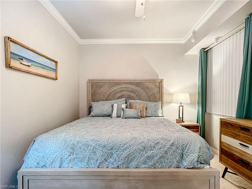 9715 Acqua Court, Unit 127 Naples, FL 34113 - Photo 30 of 50 a bedroom with a bed and wooden floor
