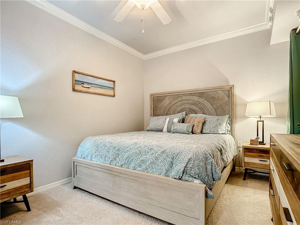 9715 Acqua Court, Unit 127 Naples, FL 34113 - Photo 31 of 50 a bedroom with a bed and a lamp on dresser
