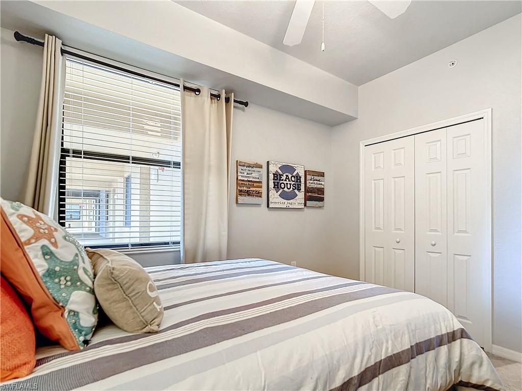 9715 Acqua Court, Unit 127 Naples, FL 34113 - Photo 37 of 50 a bedroom with a bed and a window