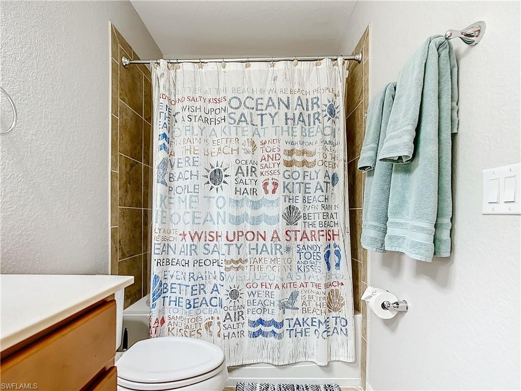 9715 Acqua Court, Unit 127 Naples, FL 34113 - Photo 41 of 50 a bathroom with a shower toilet and sink