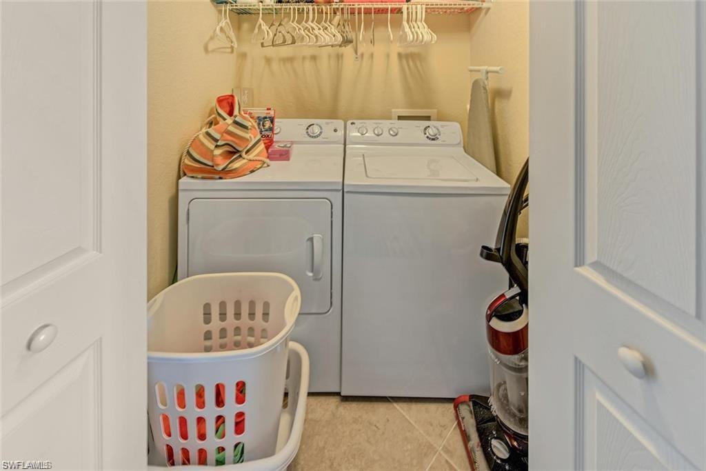 9715 Acqua Court, Unit 127 Naples, FL 34113 - Photo 42 of 50 a utility room with dryer and washer