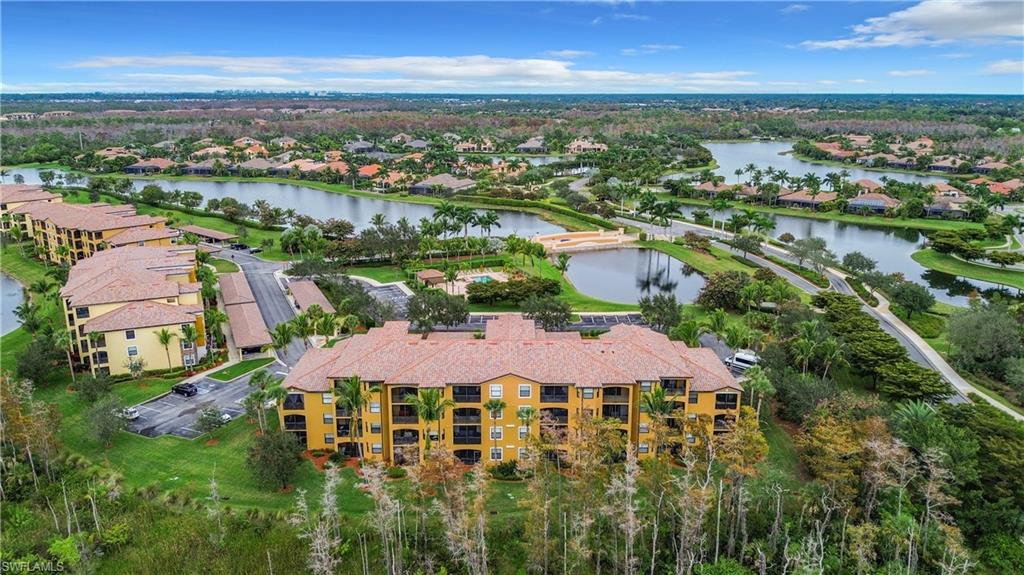 9715 Acqua Court, Unit 127 Naples, FL 34113 - Photo 46 of 50 an aerial view of residential houses with outdoor space and lake view