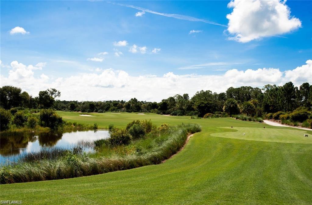 9715 Acqua Court, Unit 127 Naples, FL 34113 - Photo 47 of 50 a view of a golf course with a lake
