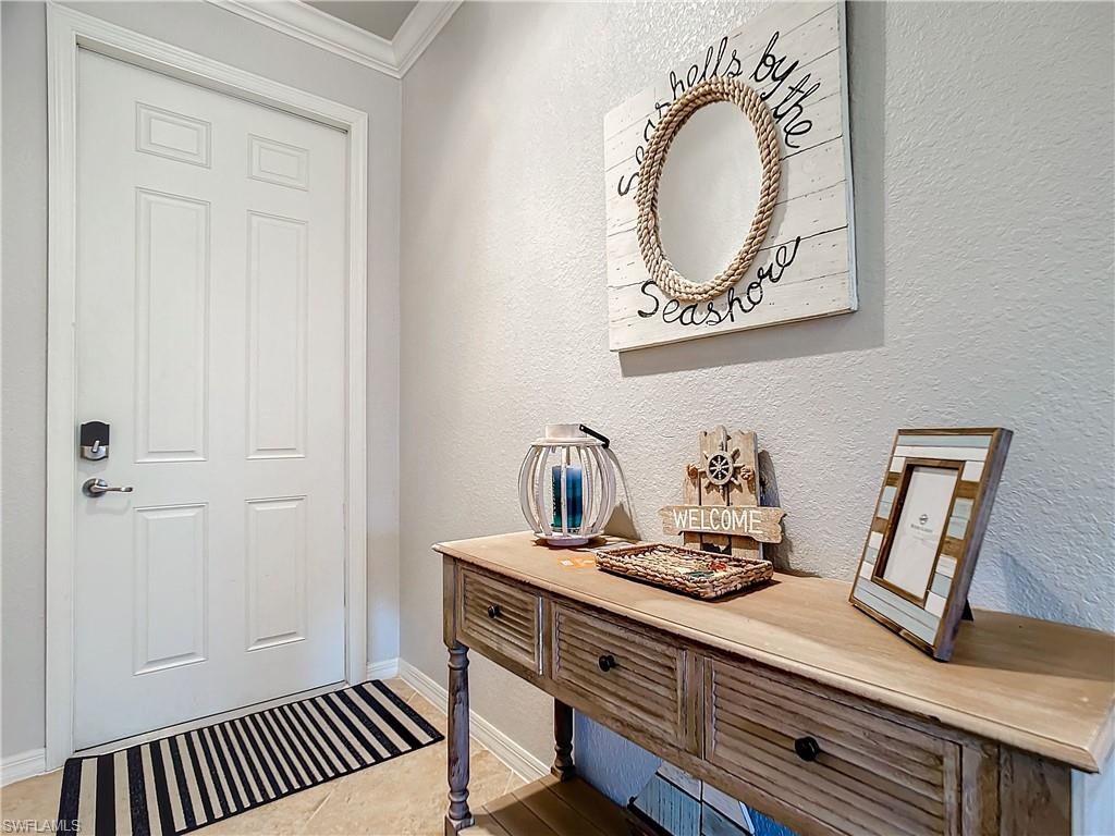 9715 Acqua Court, Unit 127 Naples, FL 34113 - Photo 8 of 50 a view of a hallway with washer and dryer