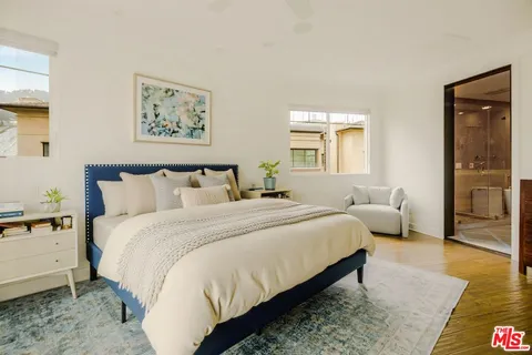 a bedroom with bed and night stand