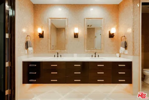 a bathroom with a sink vanity and mirror