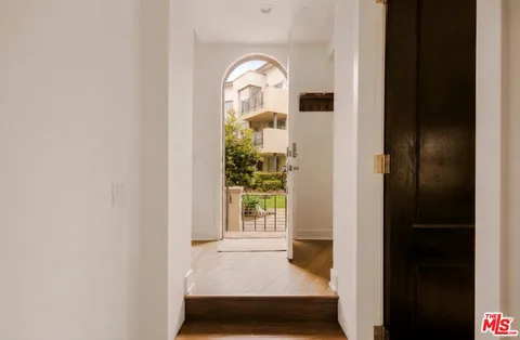 a view of a livingroom with wooden floor and a window