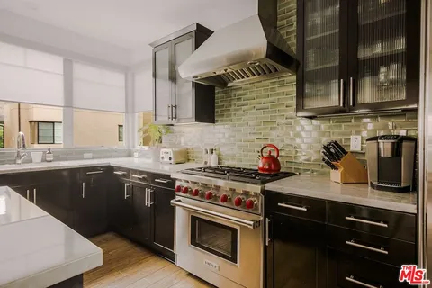 a kitchen with stainless steel appliances granite countertop a stove and a sink