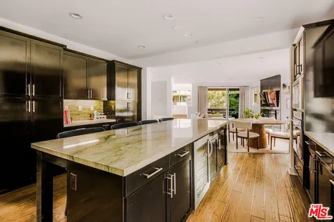 a kitchen with a sink a counter top space and stainless steel appliances