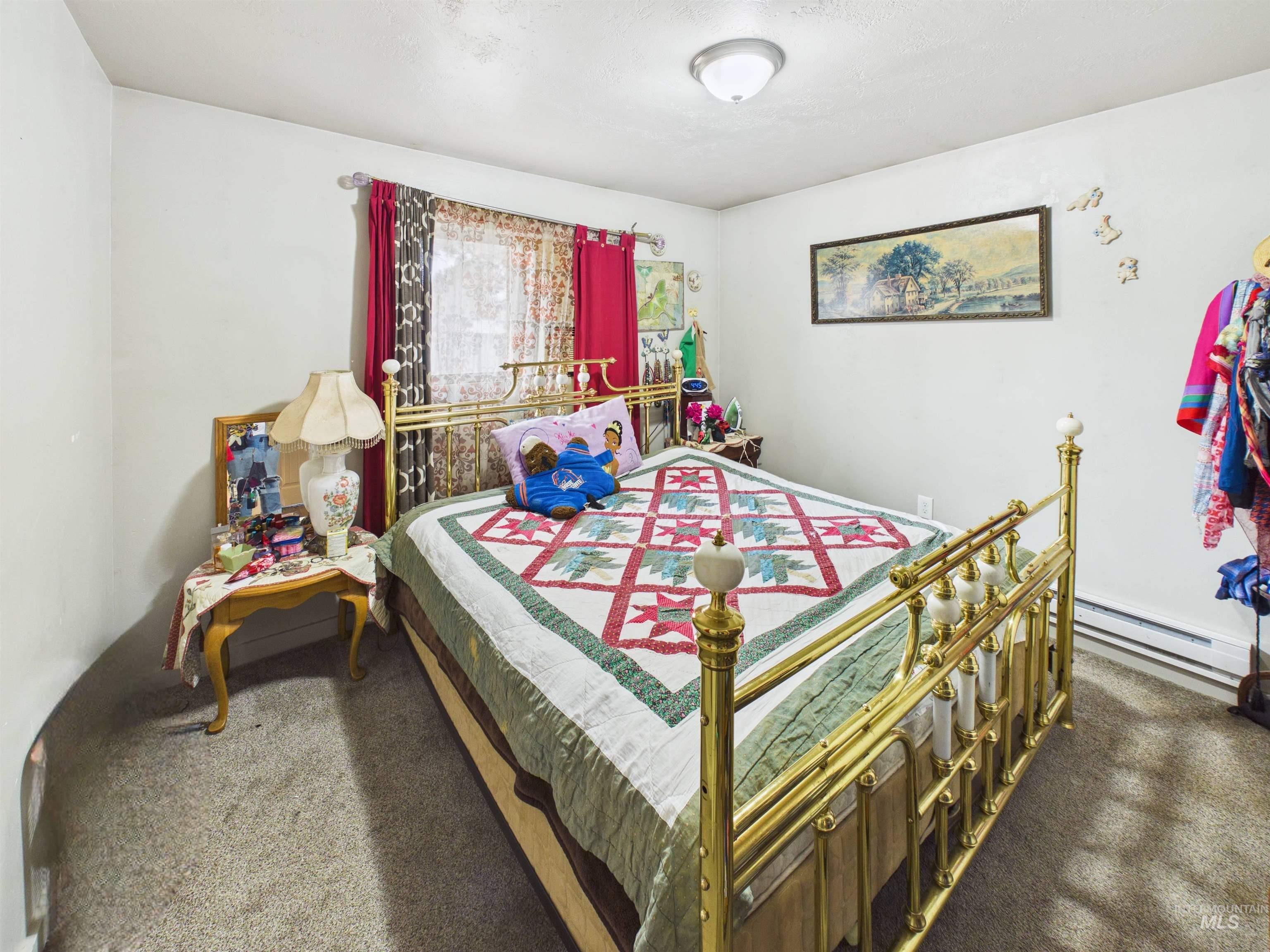 1618 Gingko Street, Unit 3 Rupert, ID 83350 - Photo 13 of 14 Bedroom featuring dark colored carpet and a baseboard heating unit