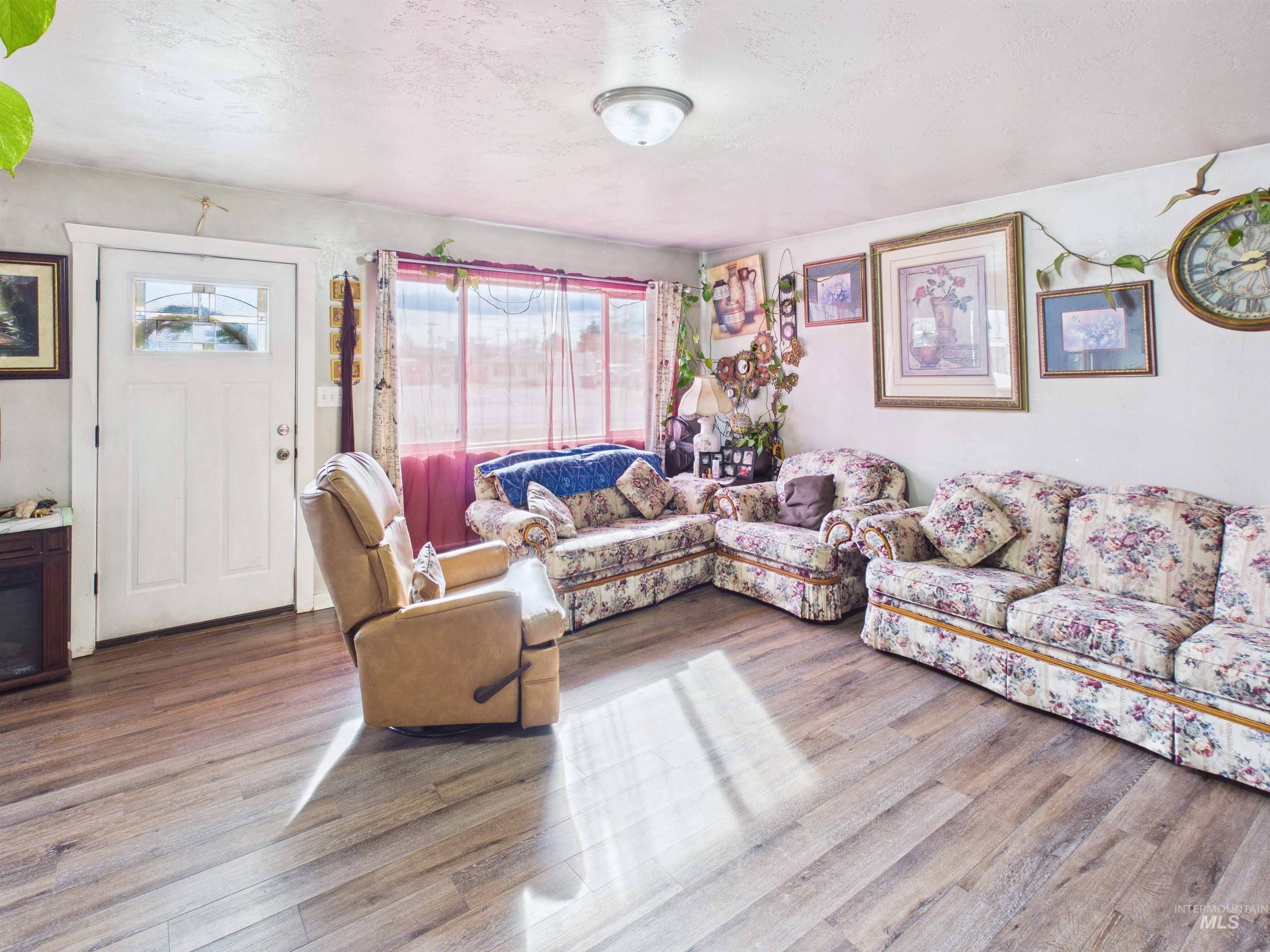 1618 Gingko Street, Unit 3 Rupert, ID 83350 - Photo 5 of 14 Living area with wood finished floors and a textured ceiling