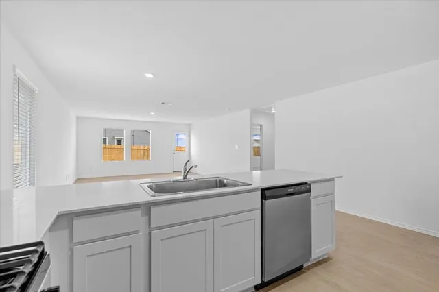 a kitchen with stainless steel appliances granite countertop a sink and a microwave