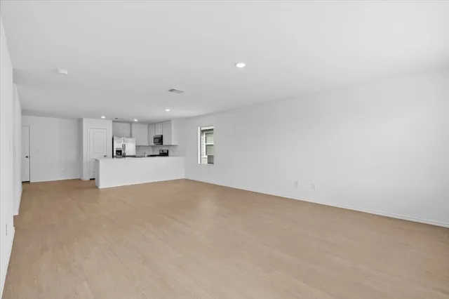 a view of a kitchen with a sink and a refrigerator