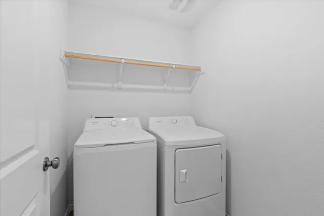 a view of a kitchen with white cabinets and sink