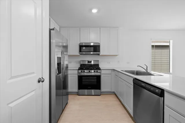 a view of empty room with wooden floor and windows