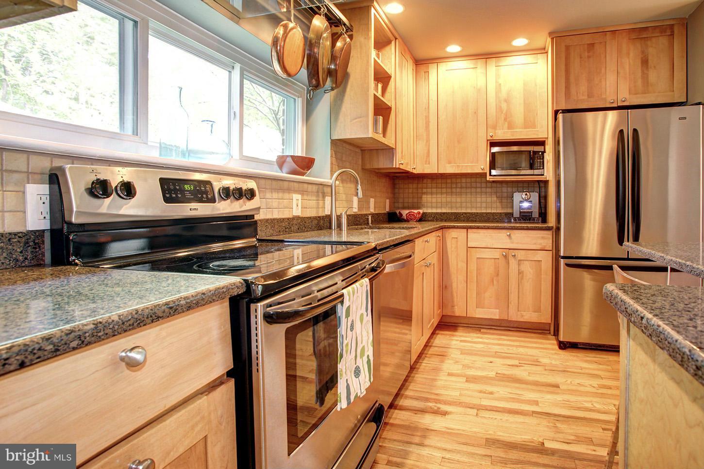 4312 Reno Road Northwest Washington, DC 20008 - Photo 11 of 29 a kitchen with stainless steel appliances granite countertop a sink a stove and a refrigerator