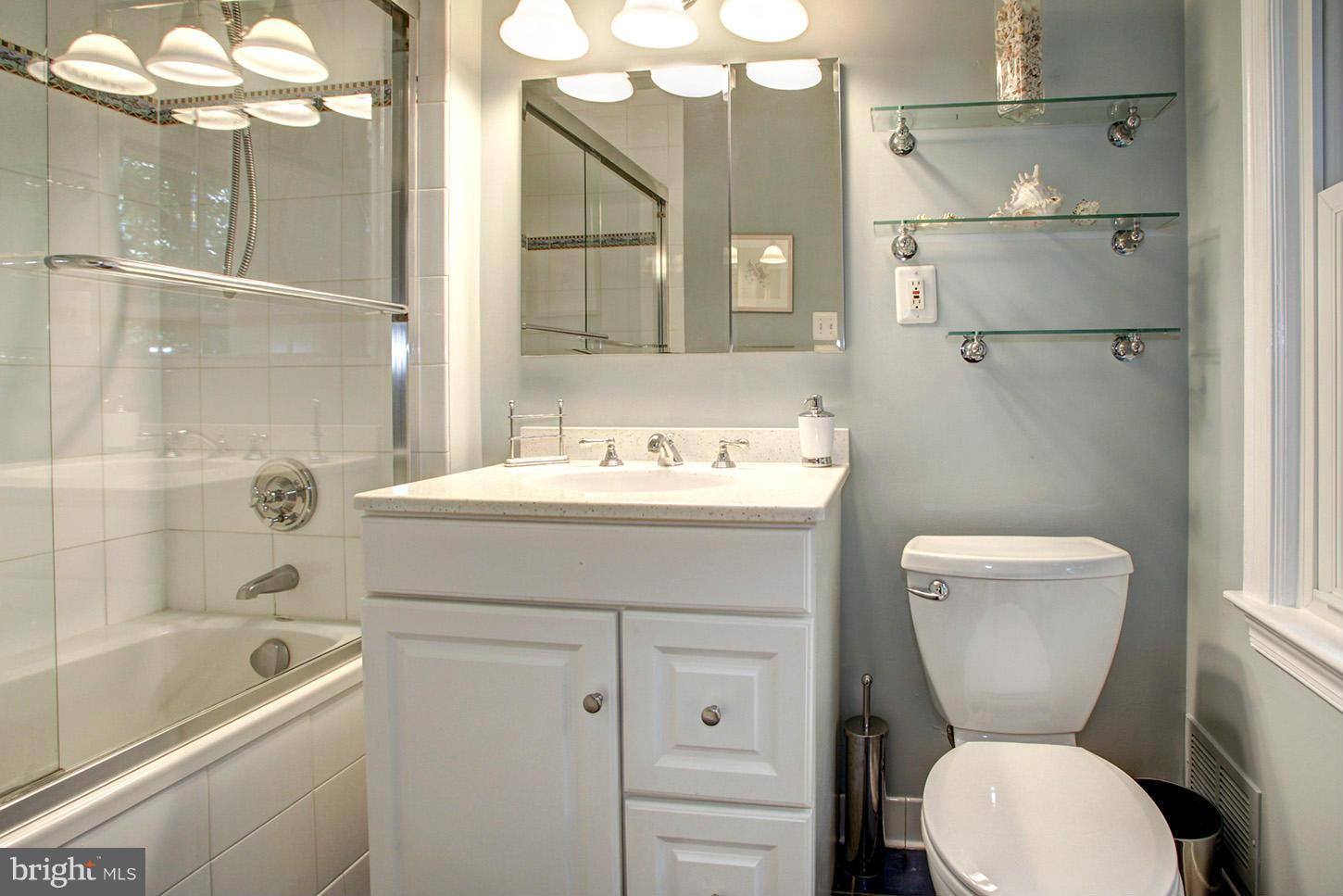 4312 Reno Road Northwest Washington, DC 20008 - Photo 15 of 29 a bathroom with a sink a toilet and shower