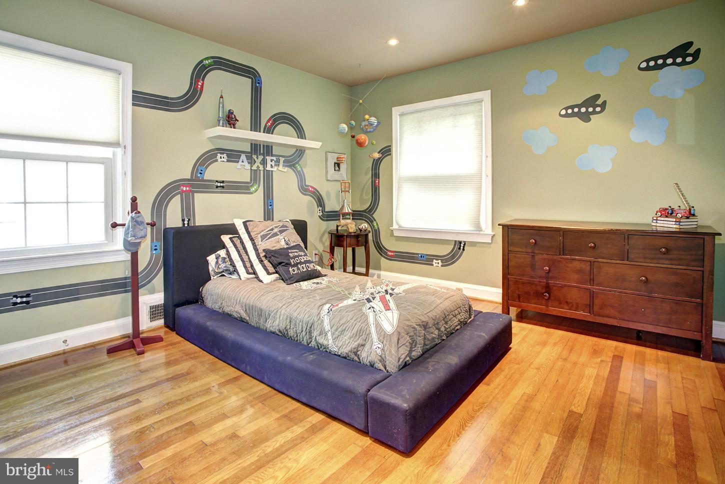 4312 Reno Road Northwest Washington, DC 20008 - Photo 16 of 29 a bedroom with a bed and wooden floor