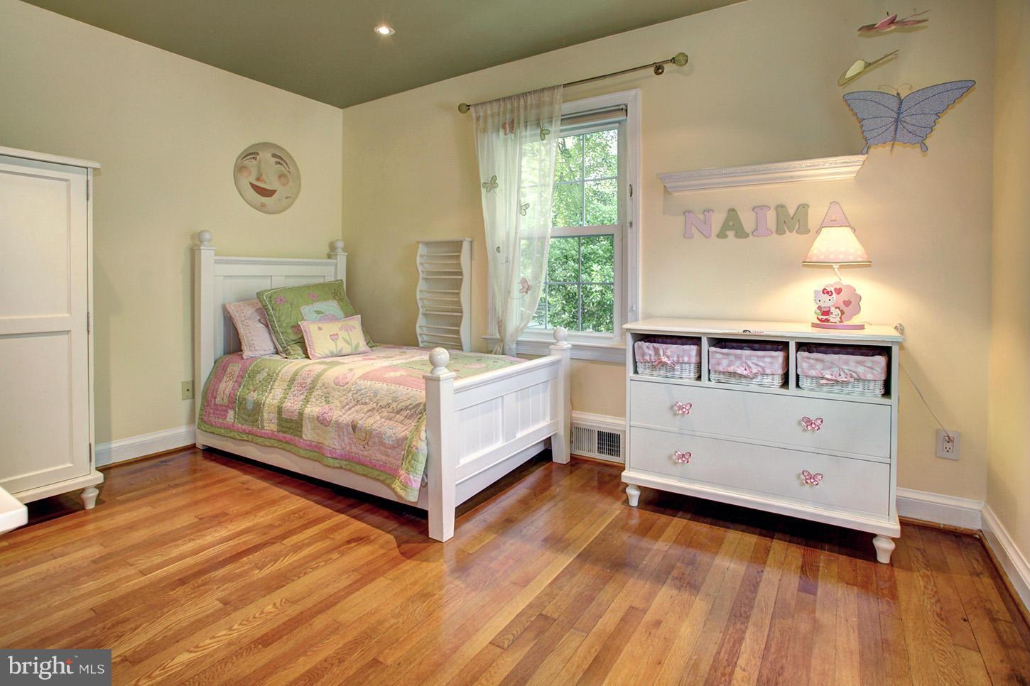 4312 Reno Road Northwest Washington, DC 20008 - Photo 17 of 29 a bedroom with a bed and a table
