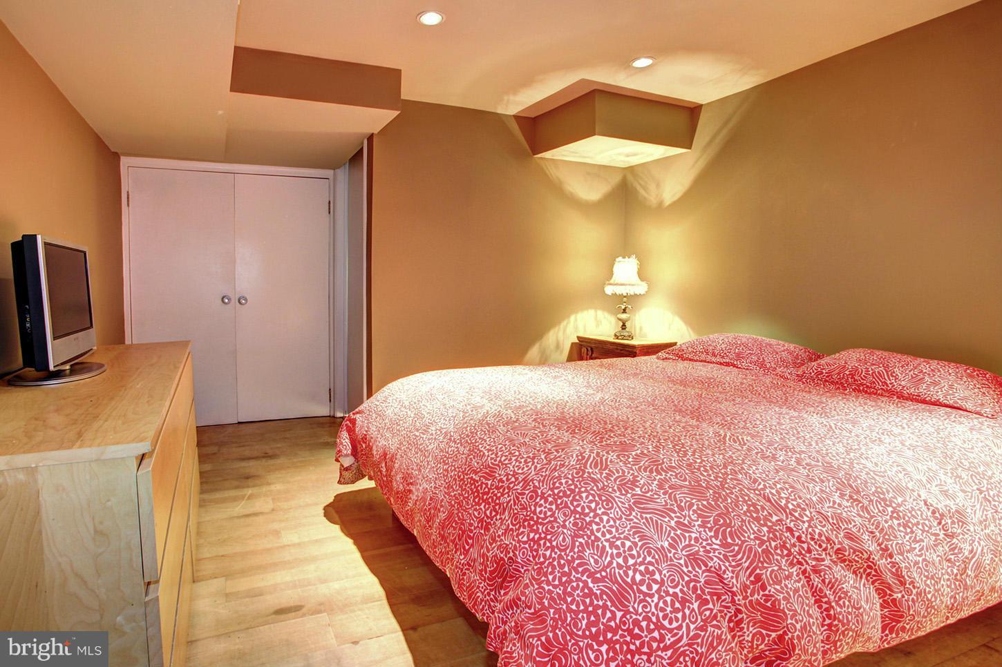 4312 Reno Road Northwest Washington, DC 20008 - Photo 24 of 29 a bedroom with a bed and a chandelier