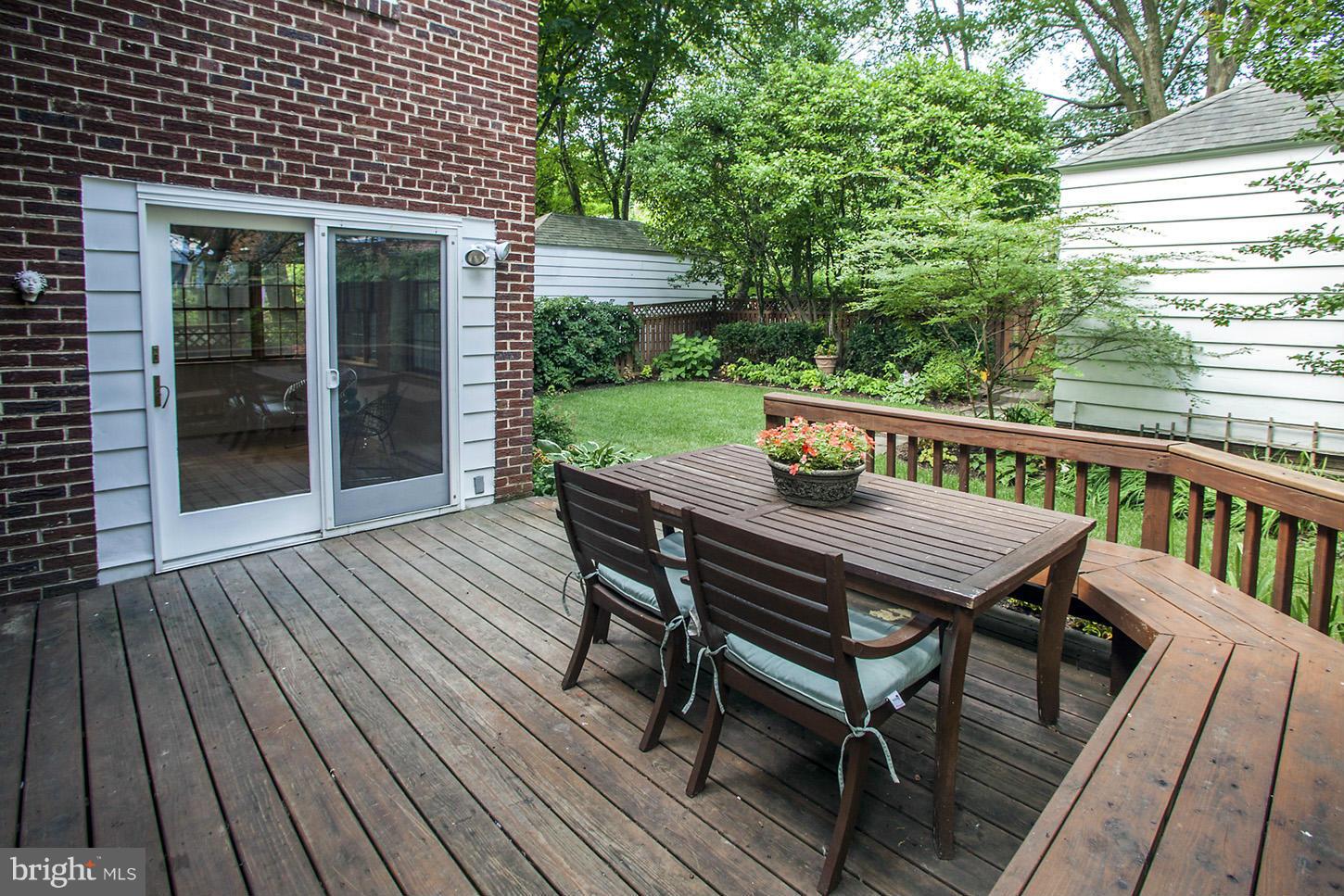4312 Reno Road Northwest Washington, DC 20008 - Photo 26 of 29 a view of a wooden deck with table and chairs