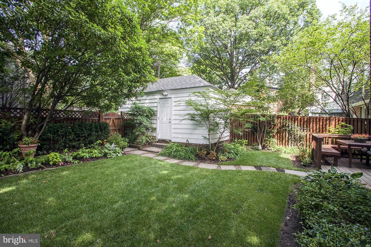 4312 Reno Road Northwest Washington, DC 20008 - Photo 28 of 29 a view of a backyard with table and chairs and a large tree