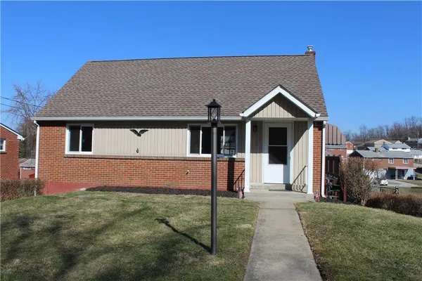 a front view of a house with a yard