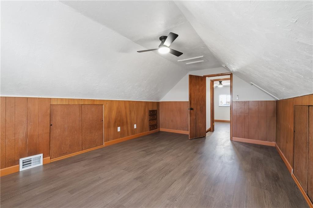 678 Colonial Manor Road Irwin, PA 15642 - Photo 16 of 30 a view of an empty room with wooden floor and a ceiling fan