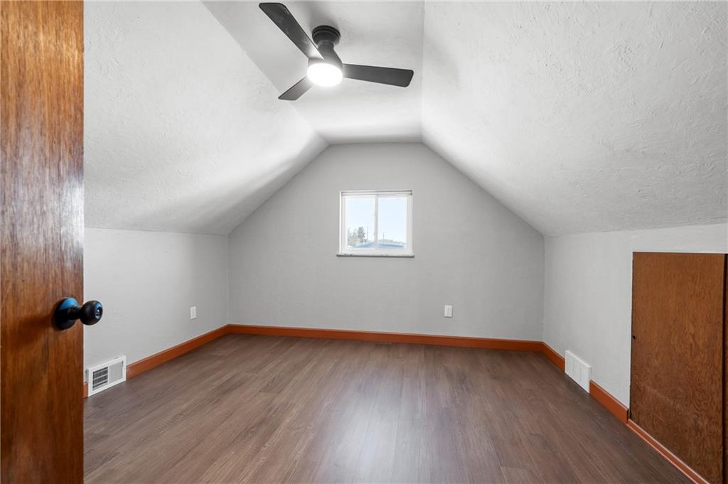 678 Colonial Manor Road Irwin, PA 15642 - Photo 19 of 30 an empty room with wooden floor and windows