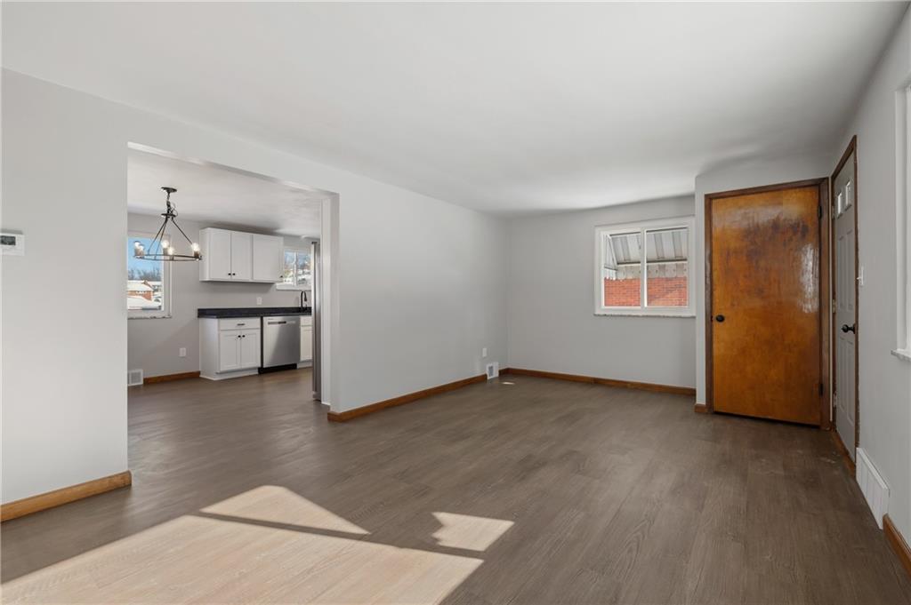 678 Colonial Manor Road Irwin, PA 15642 - Photo 4 of 30 an empty room with windows and cabinet