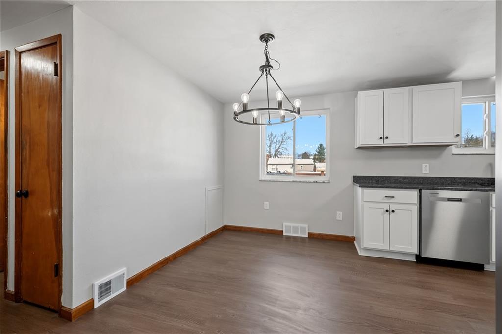 678 Colonial Manor Road Irwin, PA 15642 - Photo 5 of 30 a kitchen with stainless steel appliances granite countertop a stove a sink and white cabinets