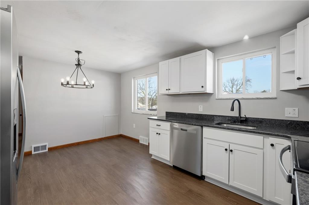 678 Colonial Manor Road Irwin, PA 15642 - Photo 8 of 30 a kitchen with granite countertop white cabinets white appliances and granite counter tops