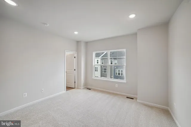 an empty room with a empty space and windows