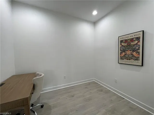 a view of a lake with table and chairs under an umbrella