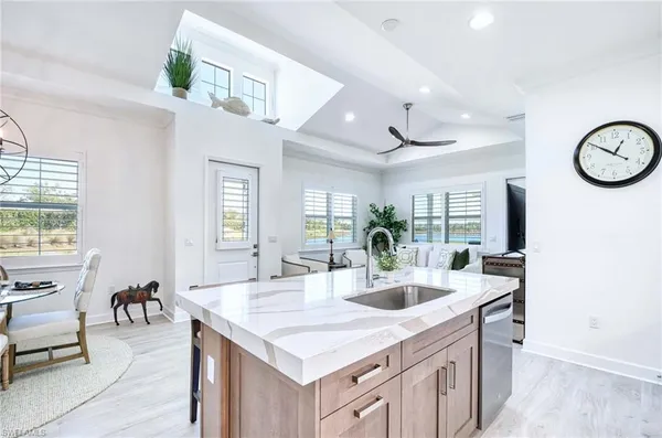 a kitchen with stainless steel appliances granite countertop a sink refrigerator and microwave