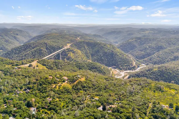 a view of a dry yard with wooden floor and a lake view