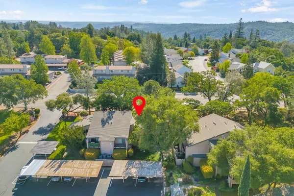 an aerial view of residential houses with outdoor space and street view