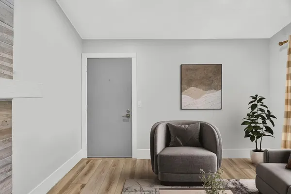a living room with a couch and a potted plant