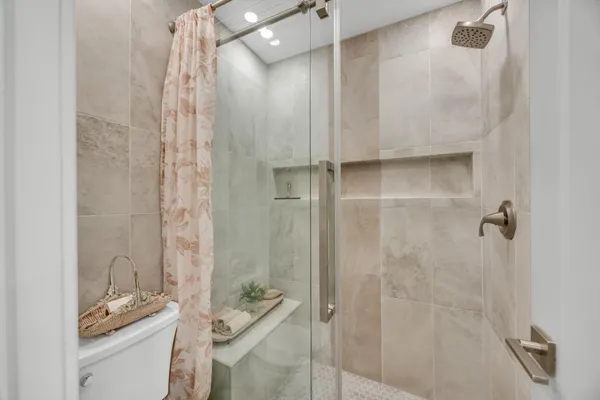 a bathroom with a granite countertop shower and a sink