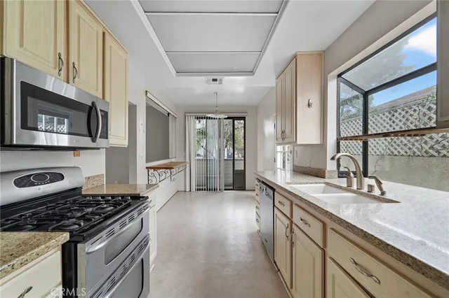 a kitchen with stainless steel appliances granite countertop a stove and a sink