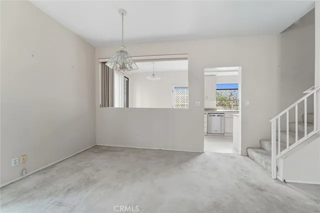 a view of a room with a window and chandelier