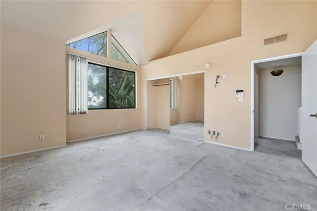 an empty room with windows and closet