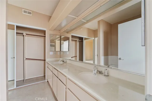 a bathroom with a double vanity sink and mirror