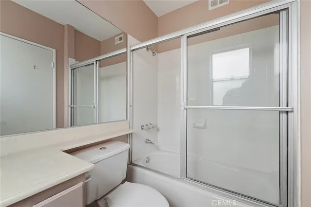 a bathroom with a shower a toilet and sink
