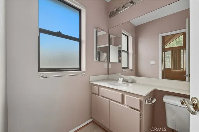 a bathroom with a sink vanity and mirror
