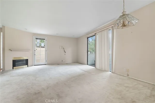 a view of empty room with a fireplace
