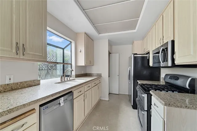 a kitchen with stainless steel appliances granite countertop a sink stove and cabinets